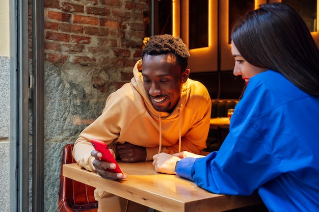 Young couple using a smartphone in a coffee shop