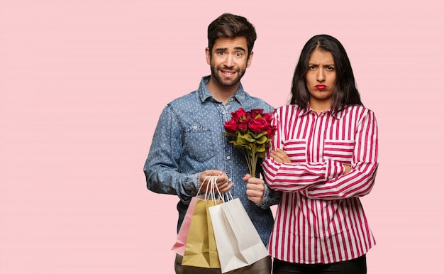 Young couple in valentines day crossing arms relaxed