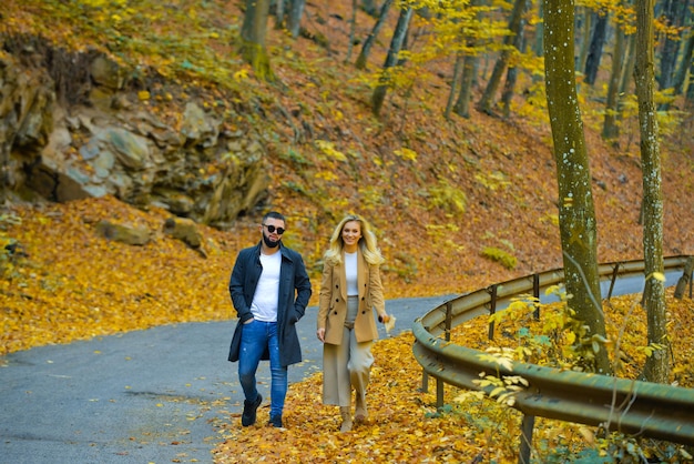 Young couple walking in the autumn park