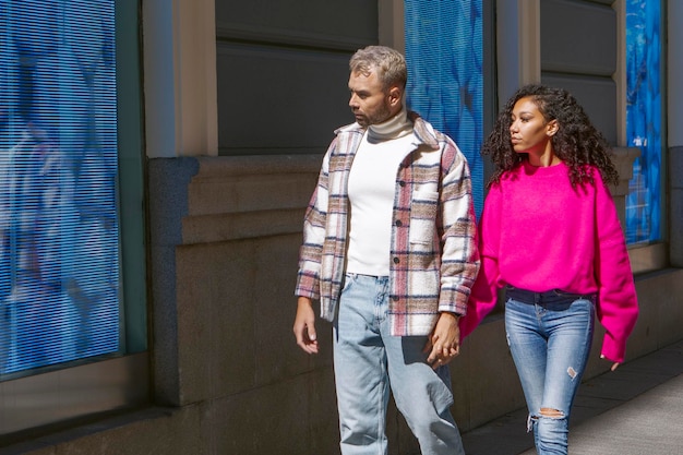 Young couple walking down a city street