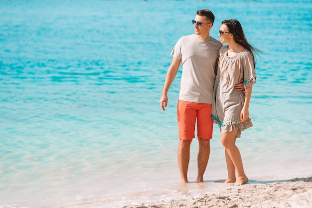 Young couple on white beach during summer vacation.