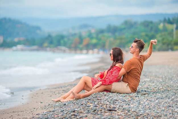 Young couple on white beach during summer vacation.