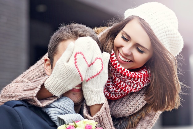 young couple with flowers dating in the city