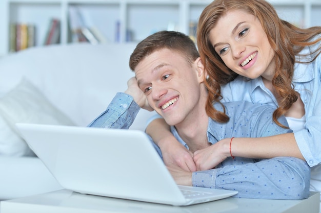 Young couple with laptop at home