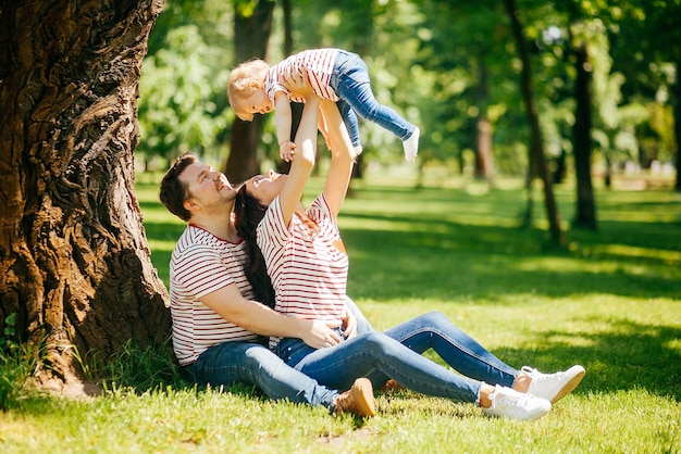 Young couple with little daughter in the park