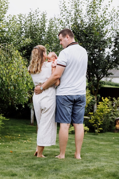 Young couple with newborn daughter in park