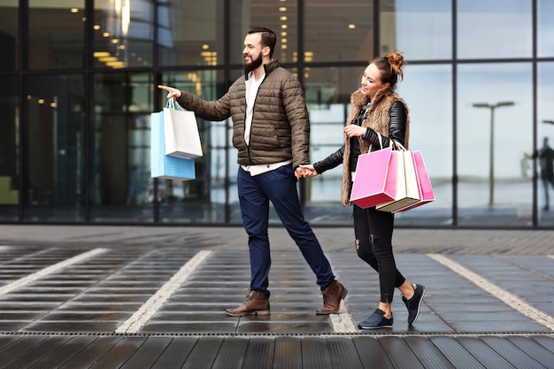 young couple with shopping bags in the city