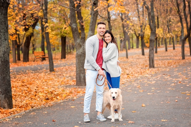 Young couple with their dog in park