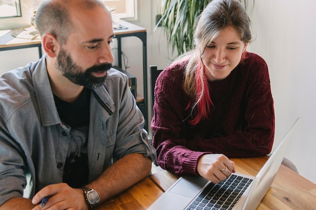 Young couple working at home holding a videoconference