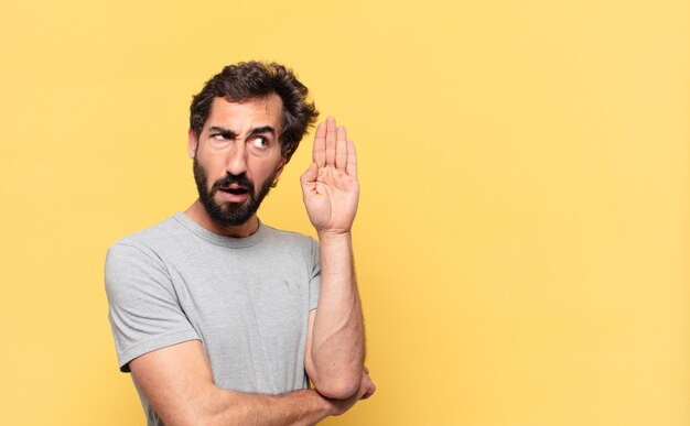 Young crazy bearded man doubting or uncertain expression