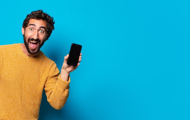 Young crazy bearded man showing his empty cell screen