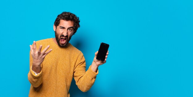 Young crazy bearded man showing his empty cell screen