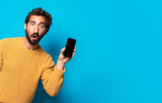 Young crazy bearded man showing his empty cell screen