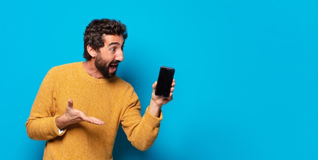 Young crazy bearded man showing his empty cell screen