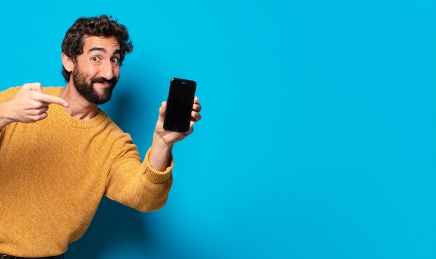 Young crazy bearded man showing his empty cell screen