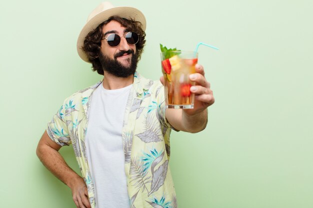 Young crazy bearded man with a cocktail. tourist concept