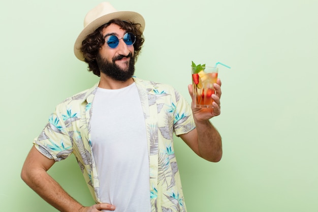 Young crazy bearded man with a cocktail. tourist concept