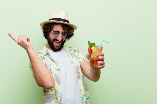 Young crazy bearded man with a cocktail. tourist concept