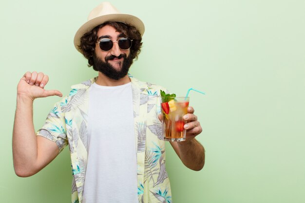 Young crazy bearded man with a cocktail. tourist 