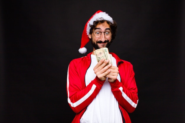 Young crazy bearded man with santa hat. Christmas concept