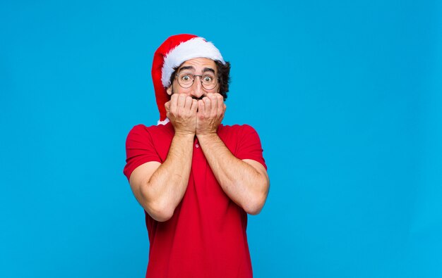 Young crazy bearded man with santa hat. Christmas concept