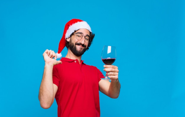 Young crazy bearded man with santa hat. Christmas concept