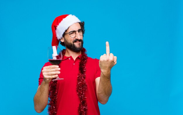 Young crazy bearded man with santa hat. Christmas concept