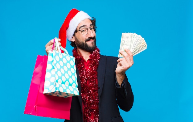 Young crazy bearded man with santa hat. Christmas concept