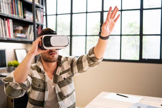 Young creative or product designer wearing VR glasses playing on Metaverse simulation