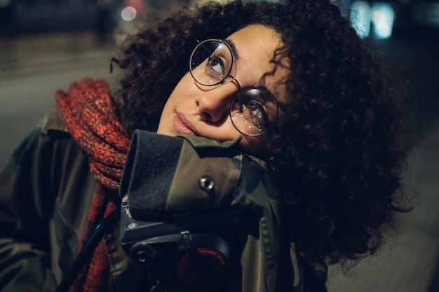 Young and curly girl looking ahead-