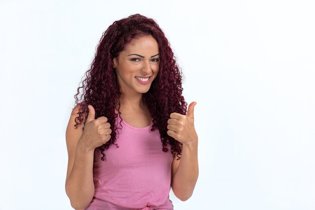 Young curly woman in a casual pink t-shirt