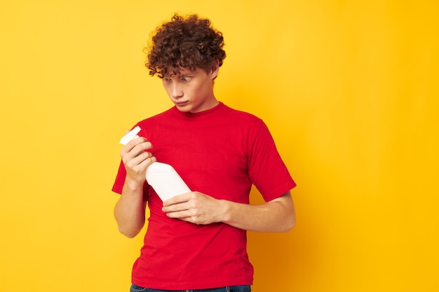 Young curlyhaired man detergent posing emotion Lifestyle unaltered