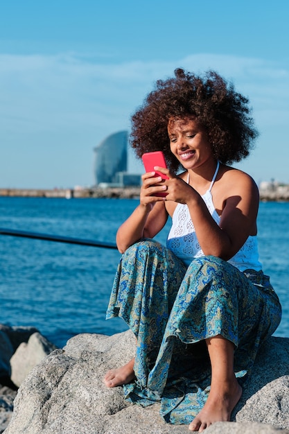 Young curvy afro woman at Barcelona beach