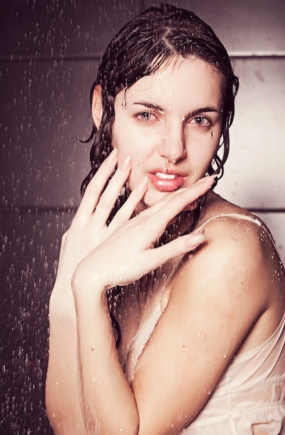 Young cute curly woman with water