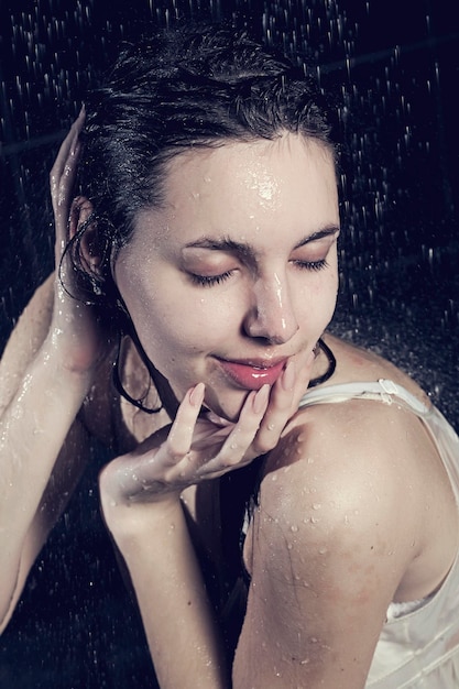 Young cute curly woman with water