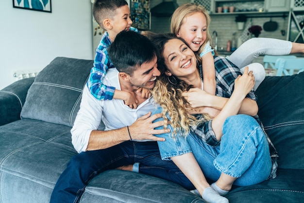 Young Cute Happy family with their sons at home having fun