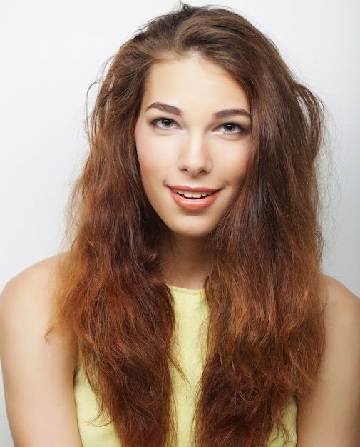 Young cute smiling blond girl, studio shot