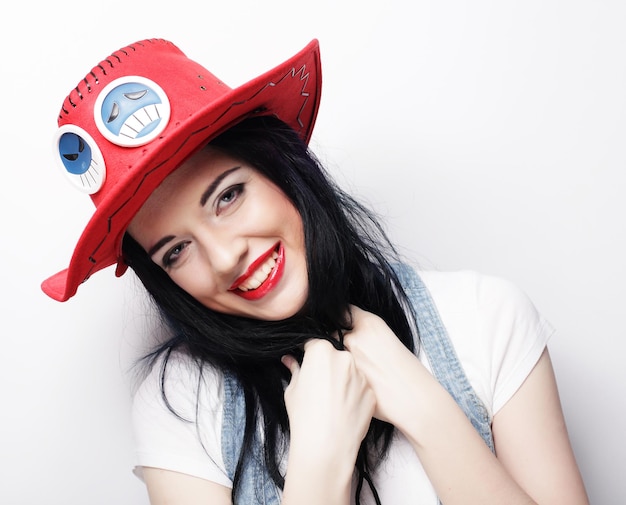 Young cute smiling brunette girl over white background