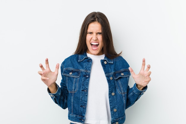 Young cute woman screaming with rage.