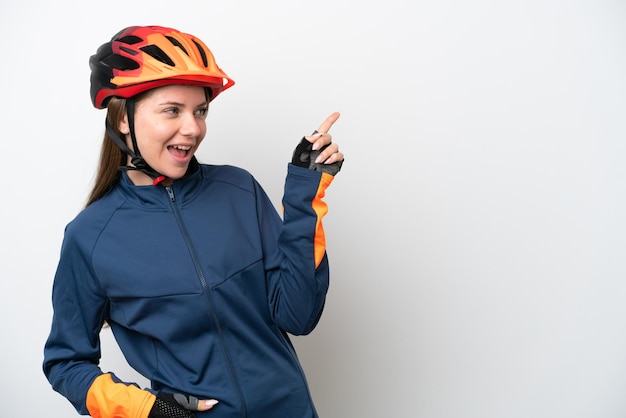 Young cyclist Lithuanian woman isolated on white background pointing finger to the side and presenting a product