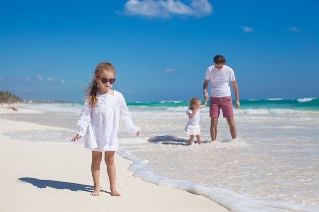 Young dad and his cute daughters enjoy summer vacation