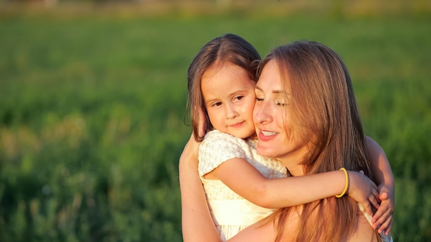 Young daughter shows pure love hugging mother closeup