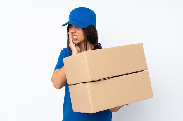 Young delivery brunette girl over isolated white wall with toothache