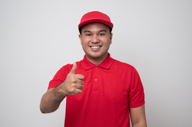 Young delivery man in a red uniform