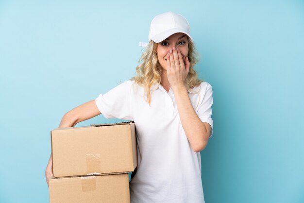 Young delivery woman over isolated wall