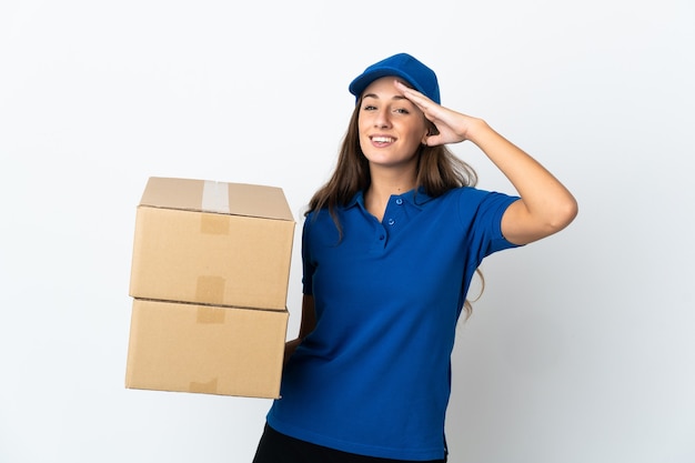 Young delivery woman over isolated white saluting with hand with happy expression