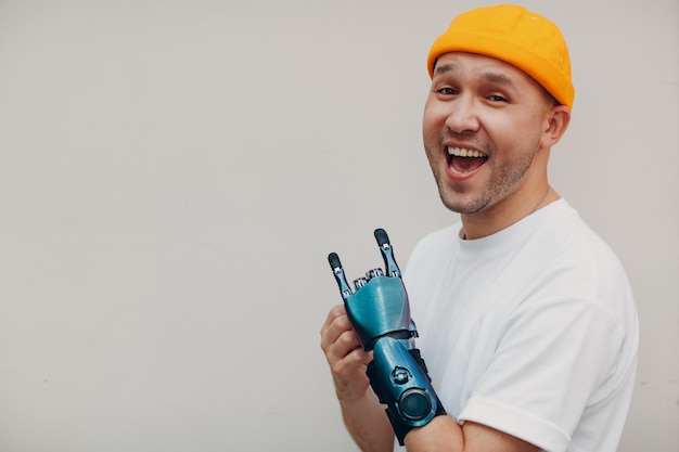 Young disabled man with artificial prosthetic hand in casual clothes