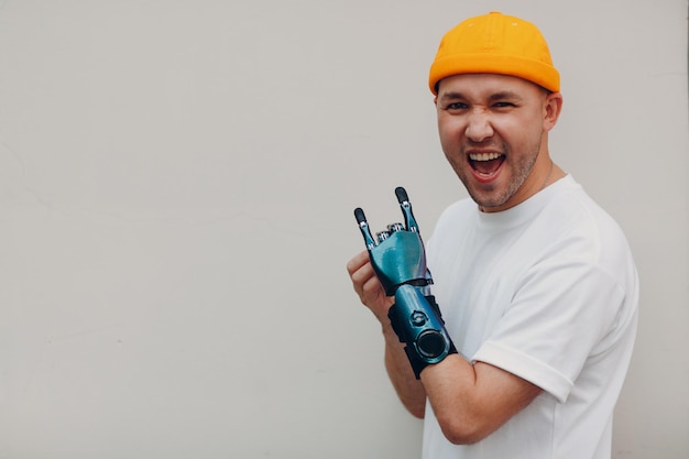 Young disabled man with artificial prosthetic hand in casual clothes