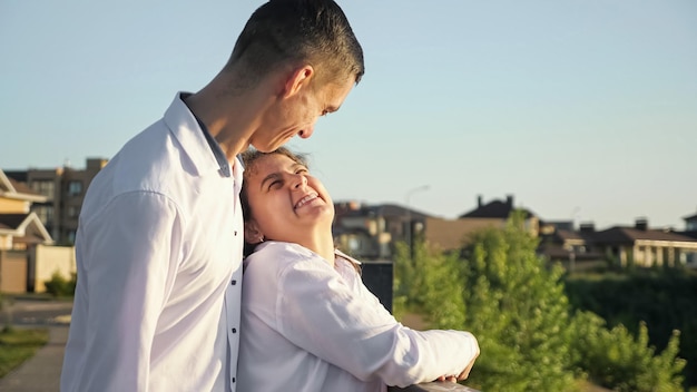 Young disabled man and woman stand on bridge smiling closeup