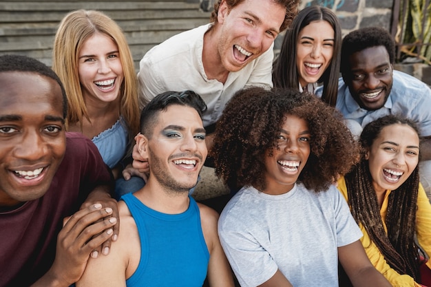 Young diverse people having fun outdoor laughing together - Focus on gay man face